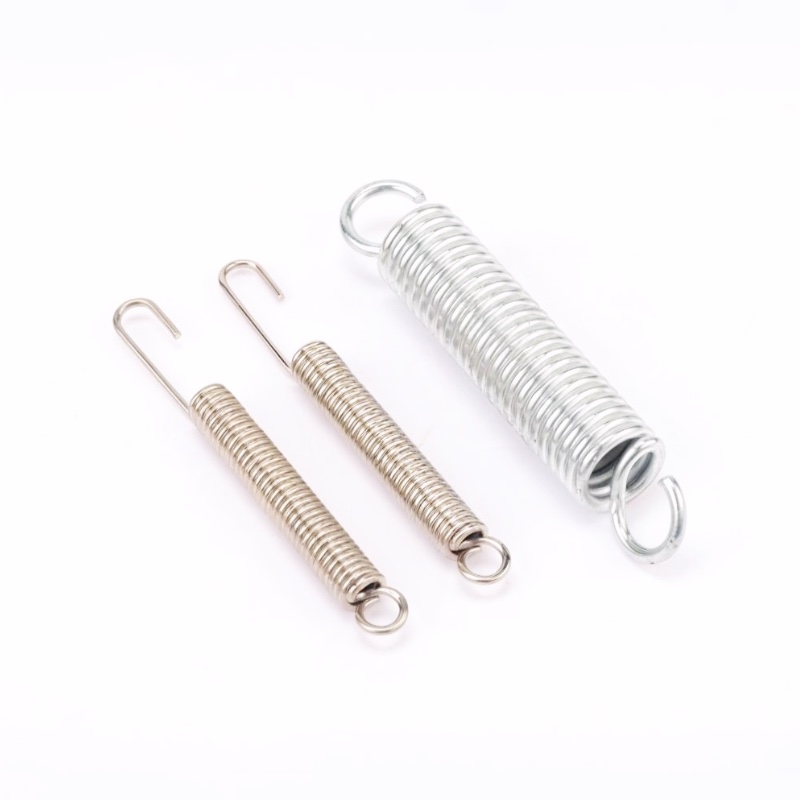 Mixed metal extension springs with hook ends