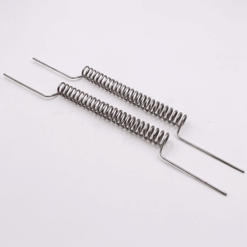 Long torsion springs with parallel bent legs