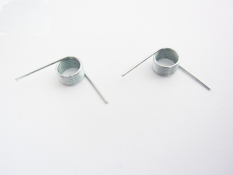 Small torsion spring pair with straight legs