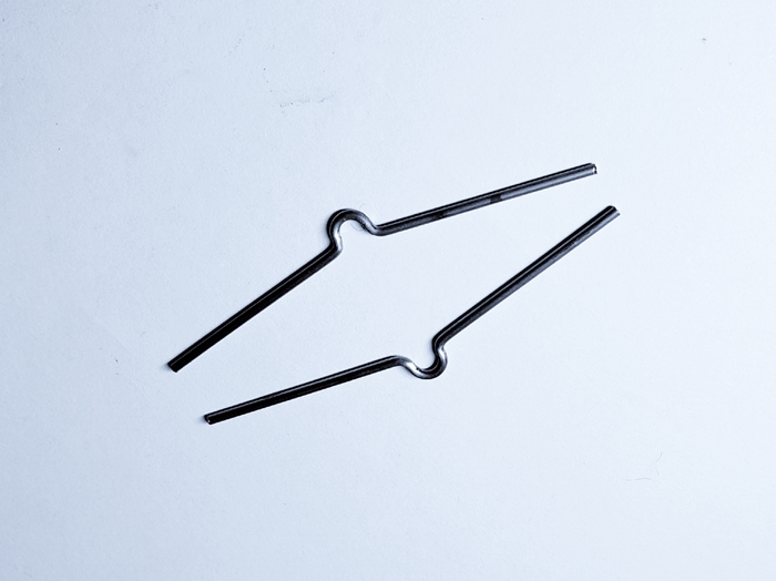 Black wire form spring clips with shaped bends